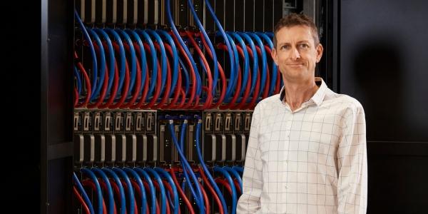 andrew turpin standing in front of server bank