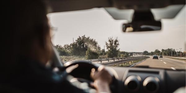 driver looking over steering wheel at road