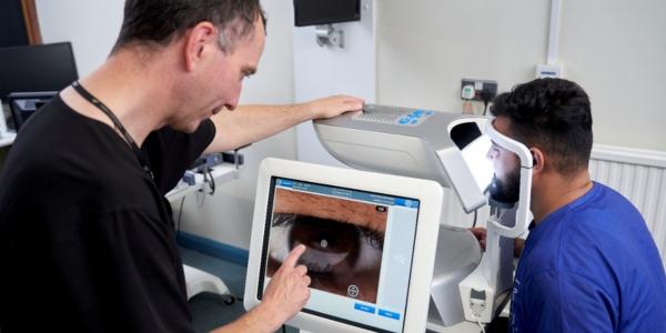 james wolffsohn at a LipiView machine looking at an image of a patient's eye