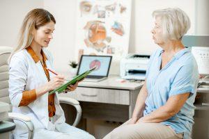 optometrist delivering diagnosis to senior patient