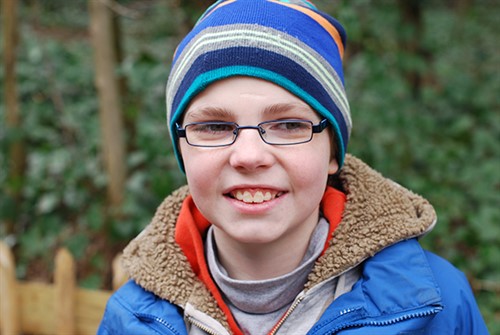 Happy boy with autism with new glasses - online